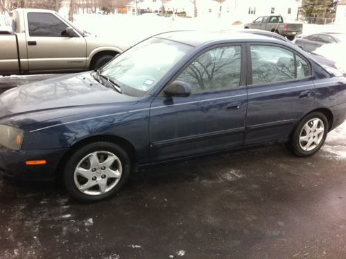 2005 hyundai elantra 133k miles. shifts smooth, idles rough. no rust, but dented