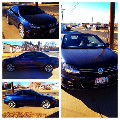 2012 volkswagen hardtop convertible; midnight blue; black leather interior.