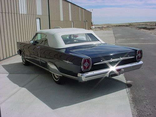 Black with black interior, buckets, console, skirts, excellent condition