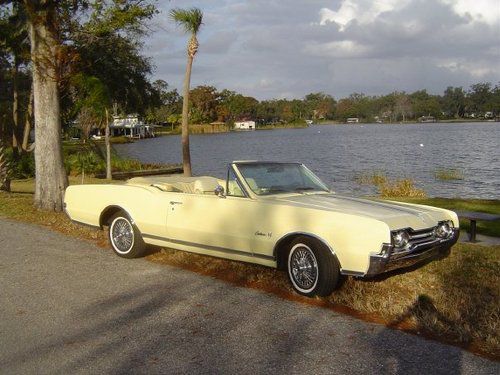 1967 oldsmobile cutlass supreme convertible loaded with yellow interior.