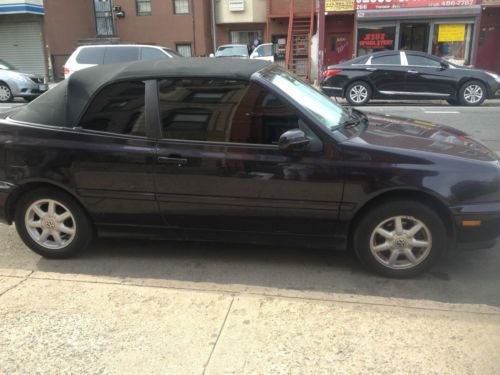 Purple black 2dr convertible with beige interior