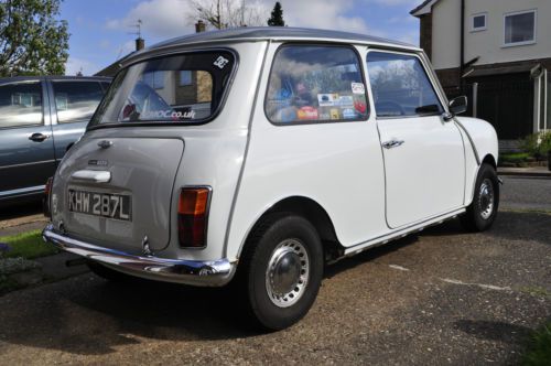 White with gray roof, 2 door sedan, sunroof, single-centre clock, 848cc engine