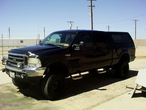 2001 f-250 xlt crew cab  6 inc lift 4 x 4 with camper shell