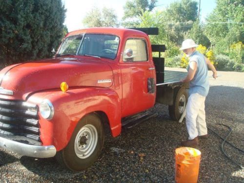 Vintage, cherry-red 3/4-ton chevy railback pickup