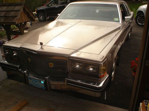 1983 cadillac coupe de ville,8 cyl,2 door,1/4 landau roof,beige.