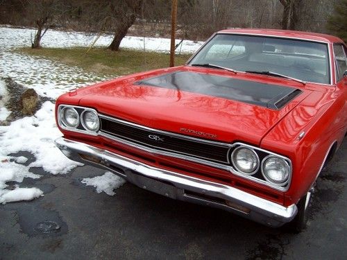 1968 gtx clone, red with white and red bucket seat interior.