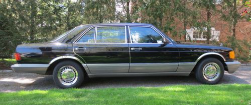 Antique . black . mercedes-benz 560 . 4-door sedan . low mileage . damage free