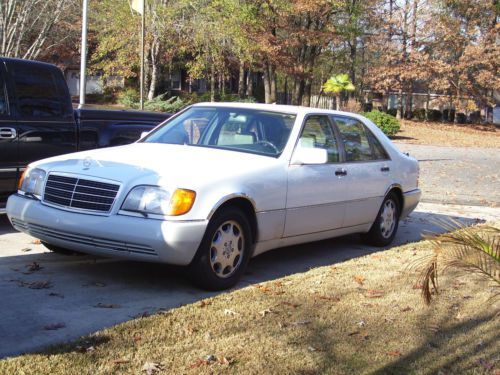 White, classic mercedes. 4-door, around 160000 miles.