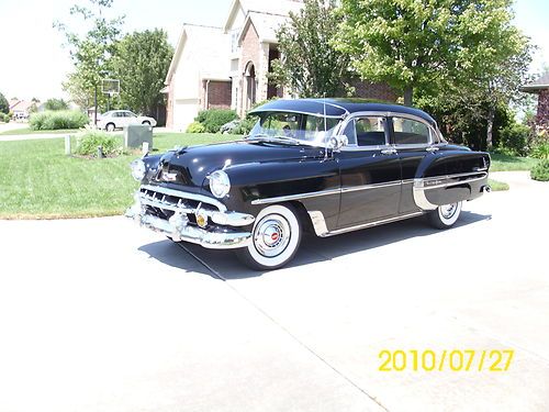 Beautiful show winning black bel air 4 door sedan loaded with chrome.