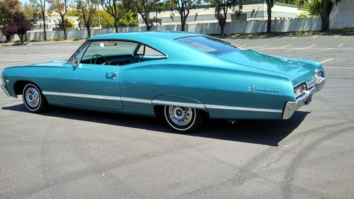 One beautiful teal 1967 impala fastback