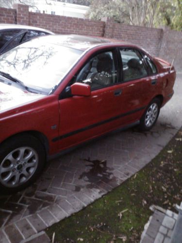 Red volvo gray leather seats four door, 4 cylinders.