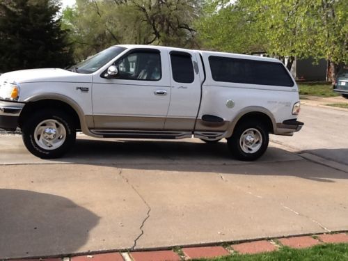 White ,lariot f150 with gold trim--4 door