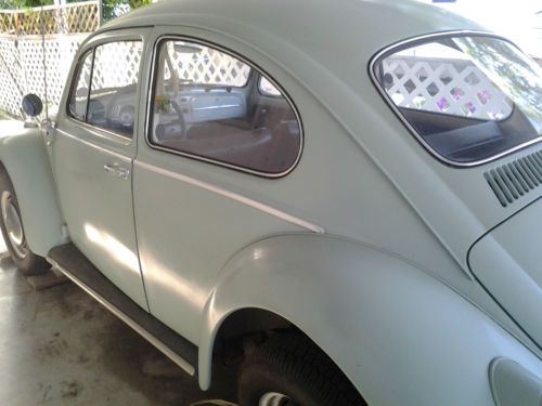 Volkswagen beetle bug all original covered in car port with auto cover