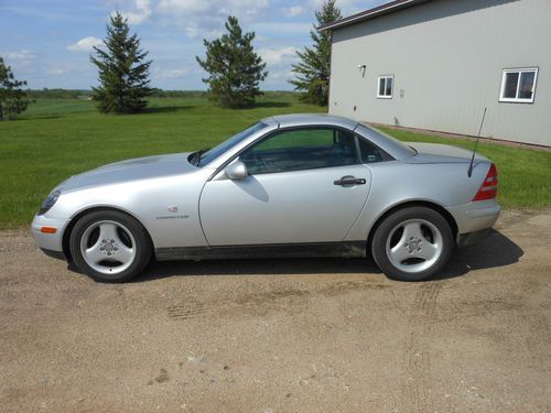 Retractable hard top; silver, leather; ac; new tires; salvage title; 98k miles