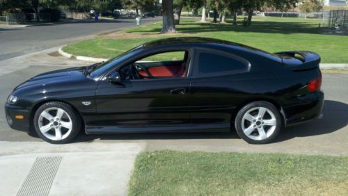 2005 pontiac gto  6.0 liter m6 phantom black with red interior (only 43k miles)