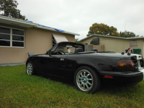 This nice black mazda with white stri from front to back .great car