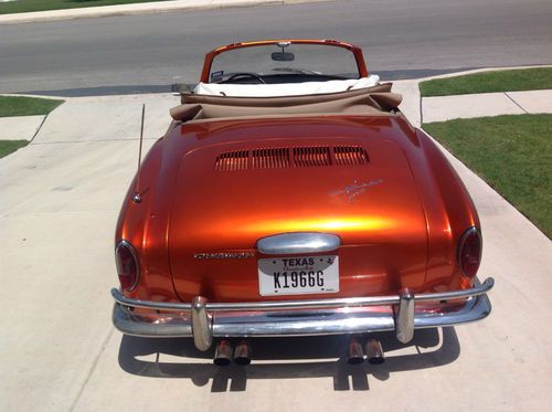 1966 karmann ghia convertible, metalic orange with beige interios and top.