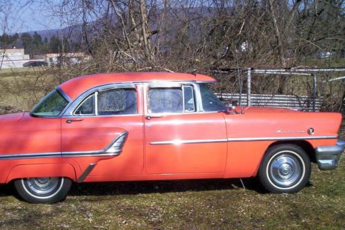 Mercury four door orange v-8 automatic