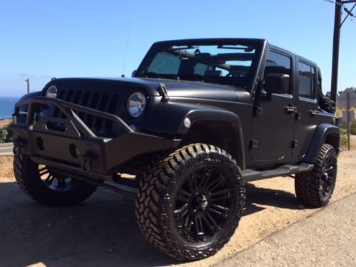 Customized jeep wrangler unlimited.  brand new bumpers, rims &amp; tires, audio etc