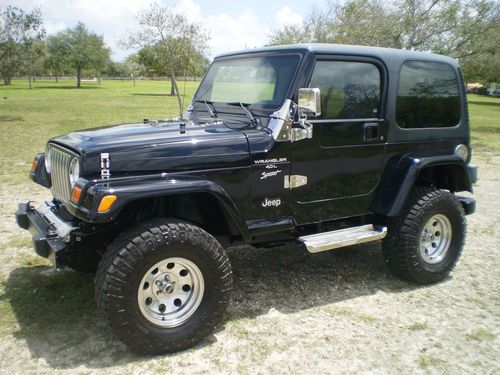 2001 jeep wrangler sport very low miles. black hard top 6 cylider rust free.