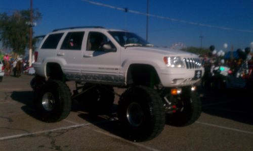 Custom lift monster jeep grand cherokee truck lifted to the sky