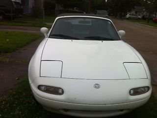 White miata with soft top in good condition