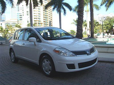 White nissan versa four door hatchback automatic