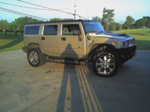 Beige 4 door utility truck with 3rd row passenger rear seat
