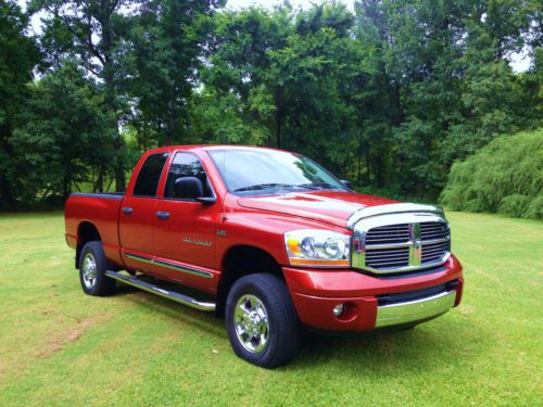 2006 red ram 2500 with grey leather, 4x4, 5.7 hemi, 4 door quad cab, bed liner,