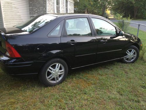 2002 ford focus 4 dr sedan, black w/ grey interior.