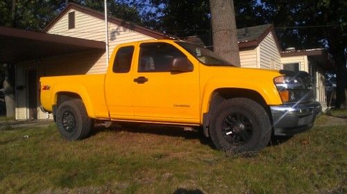Yellow chevy colorado extended cab four door