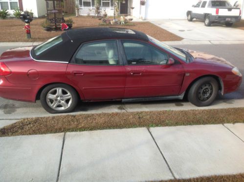 Ford taurus running but needs work.  will take best offer