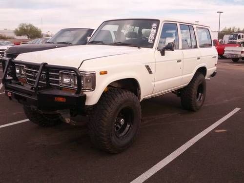 1989 toyota land cruiser fj62 4 door 4x4 lifted with 35" tires and winch bumper